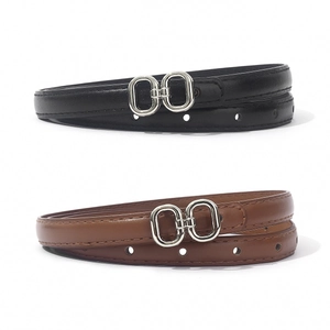 Detail of slim PU leather belts with silver double ring buckles in black and brown