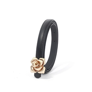 Detail of thin black PU leather belt featuring a 3D gold rose metal buckle for women