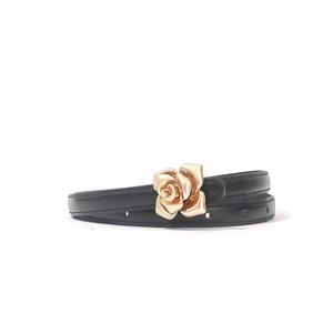 Detail of slim black PU leather belt with decorative golden 3D rose flower buckle