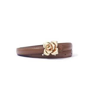 Close-up of a brown leather slim belt featuring a gold 3D rose flower metal buckle