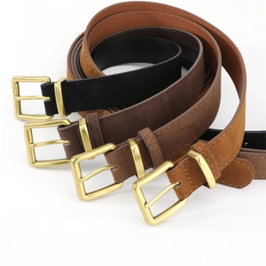 Close-up of four suede leather belts with golden square buckles in various neutral colors