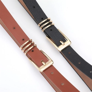 Close-up of litchi texture faux leather belts with golden buckles and decorative rings