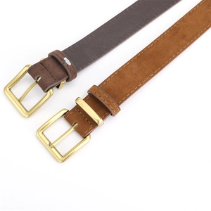 Detail of suede and smooth leather belts with polished gold rectangular pin buckles