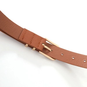 Detail of camel leather belt with premium gold pin buckle and neat stitching