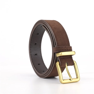 Close-up of brown suede belt with matte gold square buckle and reinforced stitching