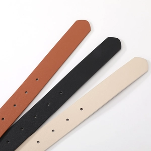 Close-up of leather belts in brown, black, and beige with natural textures and punch holes