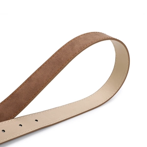 Detail of brown frosted leather belt with orange stitching and round adjustment holes