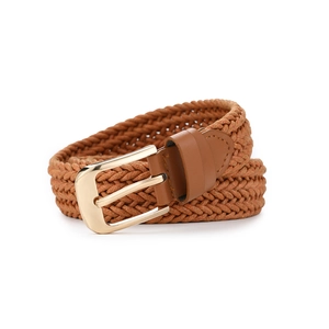 Detail of caramel brown woven rope belt with high-shine gold buckle and neat stitching