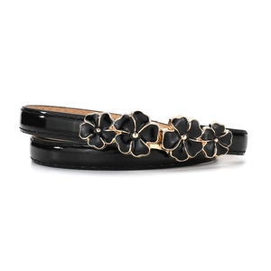 Detail of black patent leather belt with four gold-rimmed floral enamel buckles