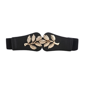 Women black elastic waist belt featuring an elegant golden leaf buckle design for dresses