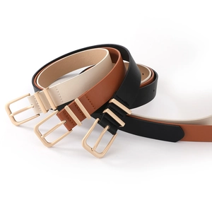 Three minimalist women's leather belts in black, brown and beige with gold metal buckles