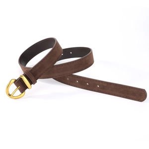 Macro view of dark brown suede leather belt with vintage golden round buckle and matte finish