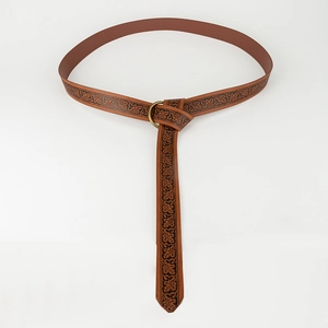 Detail of vintage brown embossed leather belt with leaf pattern and brass ring buckle