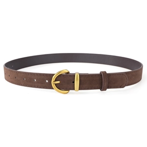 Macro shot of dark brown faux suede belt featuring a vintage brass D-ring buckle and fine holes