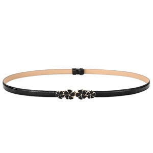 Black patent leather skinny belt for women with golden flower buckle on white background