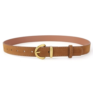 Macro detail of brown faux suede belt with golden horseshoe buckle and stitching