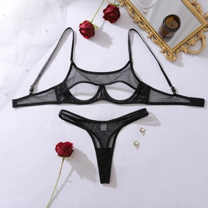 Flat lay of sexy black mesh lingerie set with hollow bra and matching thong