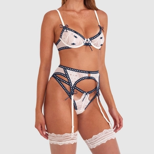 Weißes Spitzen-Lingerie-Set mit dunkelblauen Bändern und 3D-Blumen am Model präsentiert