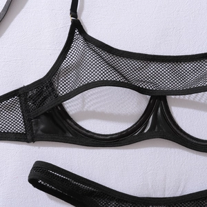 Detail of black open cup lingerie set with mesh and glossy faux leather texture
