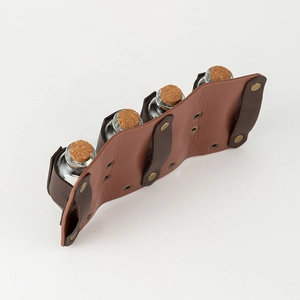 Detail of medieval Viking leather belt holder with four glass alchemy potion bottles