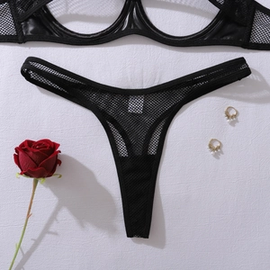 Detail of black mesh lace lingerie set with T-back thong and metallic accents on white backdrop