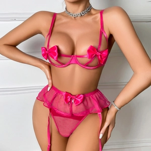 Dettaglio del set di lingerie rosa acceso con fiocchi e trama in rete a pois eleganti