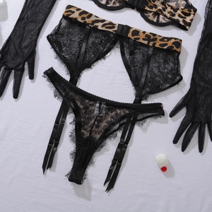 Flat lay of leopard print lace lingerie set with matching sheer mesh gloves and garter