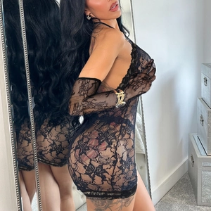 Detail of sheer floral lace lingerie set with matching elbow length gloves in black