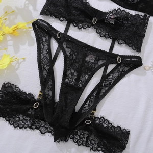 Detail of floral eyelash lace lingerie set featuring black gemstone and gold metal clips