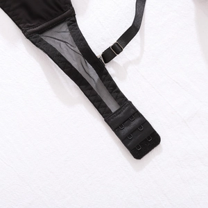 Detail of black lace lingerie set featuring three-row back hooks and mesh texture