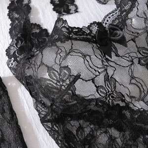Detailed macro view of black floral lace fabric with a satin bow on a slim fitting lingerie set