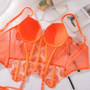 Detailed close-up of orange floral lace corset bra with supportive boning structure
