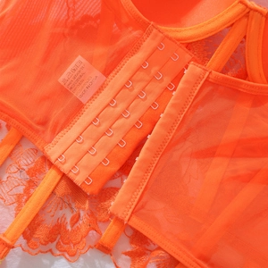 Close-up of bright orange floral embroidery lingerie with six-row hook and eye closure