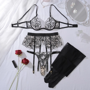 Flat lay of black lingerie set with snake pattern embroidery and lace details