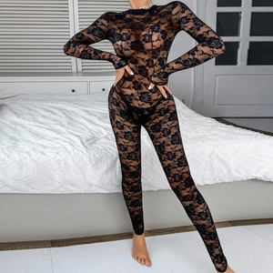 Detail of black floral lace bodysuit with high neck and long sleeves in bedroom setting