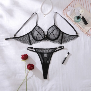 Detailed macro view of black eyelash lace texture and sheer mesh on the lingerie set