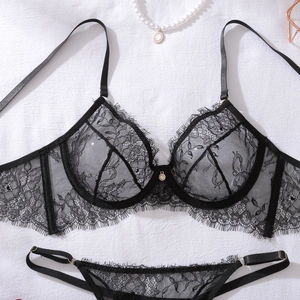 Detailed flat lay of black eyelash lace lingerie set with intricate floral patterns