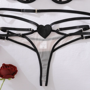 Detail view of sheer mesh lingerie set with metal rings and faux leather heart patch
