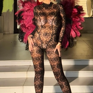 Sultry black lace long sleeve bodysuit with floral patterns and feather wing accessories