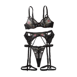 Three-piece black lace lingerie set with floral embroidery and garter belt