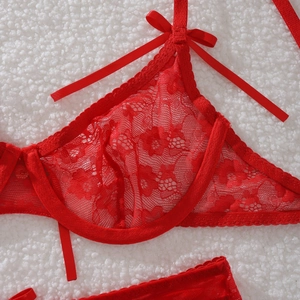 Close-up of red floral lace bra featuring eyelash edges and a small silk bow detail