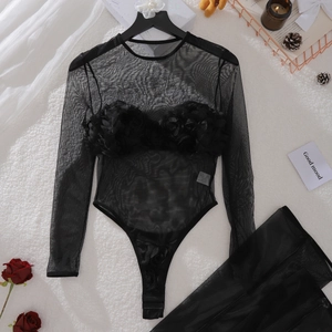Detailed view of black mesh bodysuit with 3D floral accents and snap closure