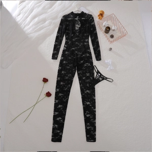 Flat lay of black lace see-through bodysuit set with neck cutout on white fur background
