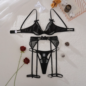 Détail d'un ensemble de lingerie en dentelle noire avec nœuds et porte-jarretelles