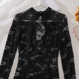 Detail of black floral lace bodysuit with high neck and teardrop back cutout design
