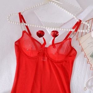 Detail of red sheer mesh bodysuit featuring sequin hearts and fringe tassels