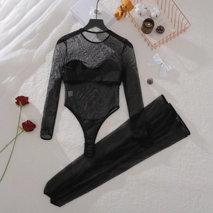 Flat lay of black mesh bodysuit and leggings set on white faux fur with roses