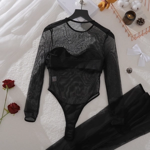 Detailed view of black sheer mesh bodysuit with padding on a plush white background