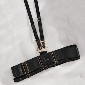 Detailed view of adjustable black lingerie straps with gold metal rings and lobster clasps
