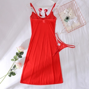 Flat lay of red mesh sheer chemise set with adjustable straps and matching thong on bed